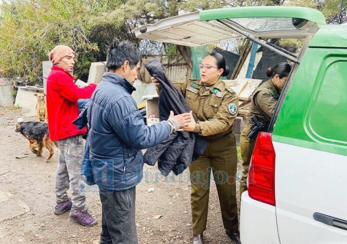 Funcionarias entregando chaquetas que llevan en el tradicional furgón de la MICC.