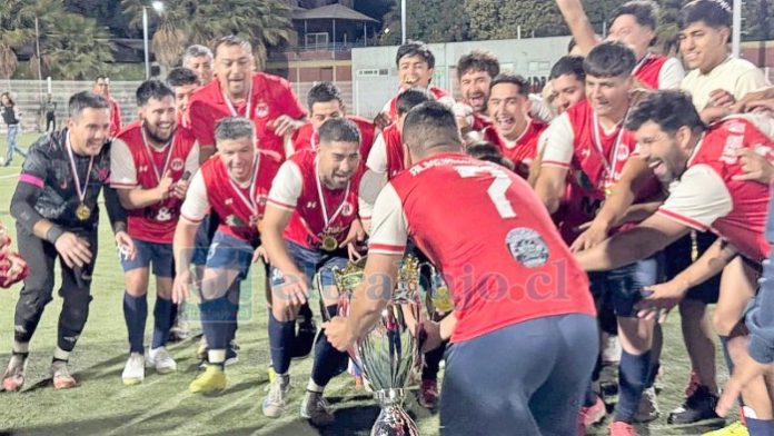 Uno de los equipos campeones de Almendral Alto se apresta a levantar el trofeo que los acredita como los mejores de su serie.